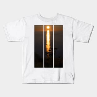 Wonderful landscapes in Norway. Nord-Norge. Beautiful scenery of a midnight sun sunset at Nordkapp (Cape North). Boat and globe on a cliff. Rippled sea and clear orange sky. (vertical) Kids T-Shirt